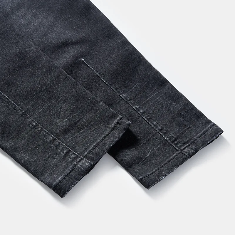 kids-black-whisker-wash-distressed-slim-jeans-s26wjkj105-finished-hem-detail