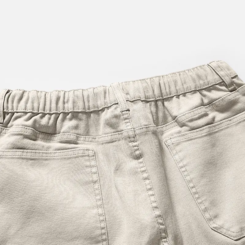 Back waist and patch pocket detail on beige pants style 4E801