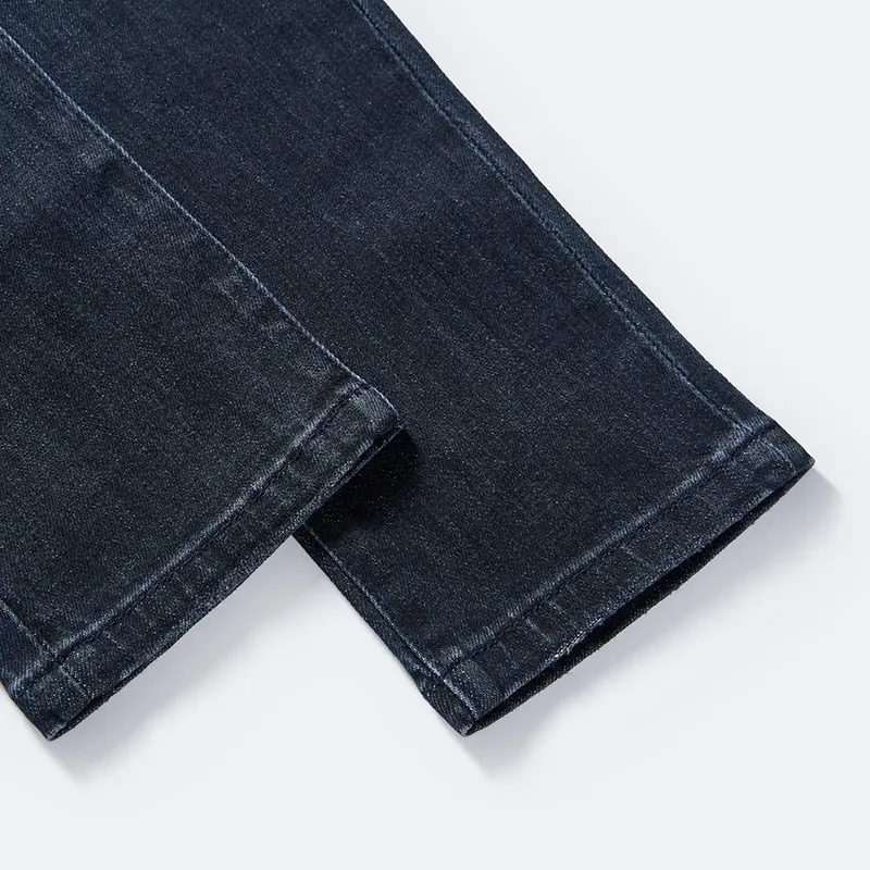 Clean tapered hem and seam detail on dark indigo jeans style DJFW2508M