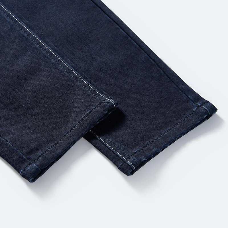 Clean tapered hem and seam detail on dark indigo jeans style 68010